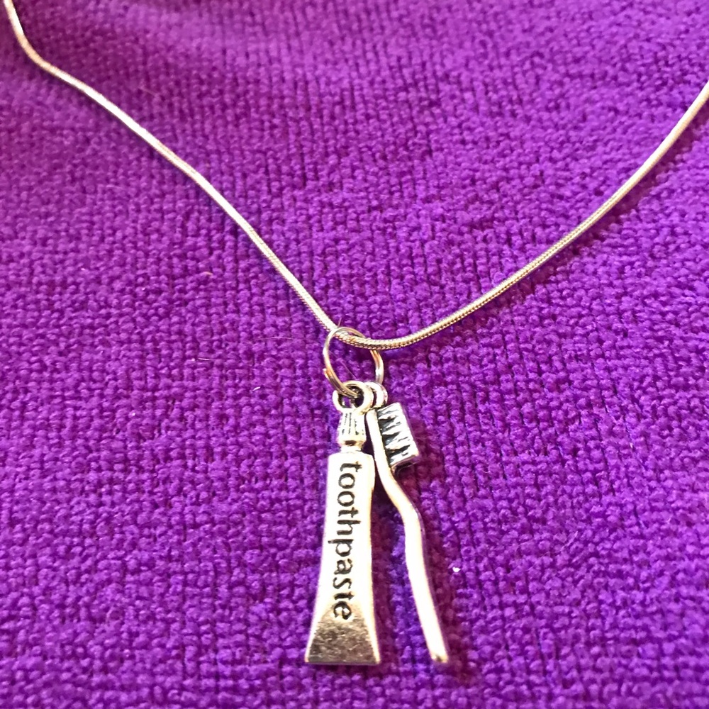 Whimsical toothbrush and toothpaste necklace.